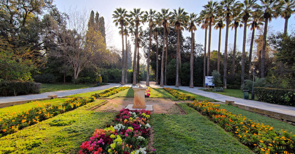 Panoramic view of the National Garden of Athens, full of trees and flowers.