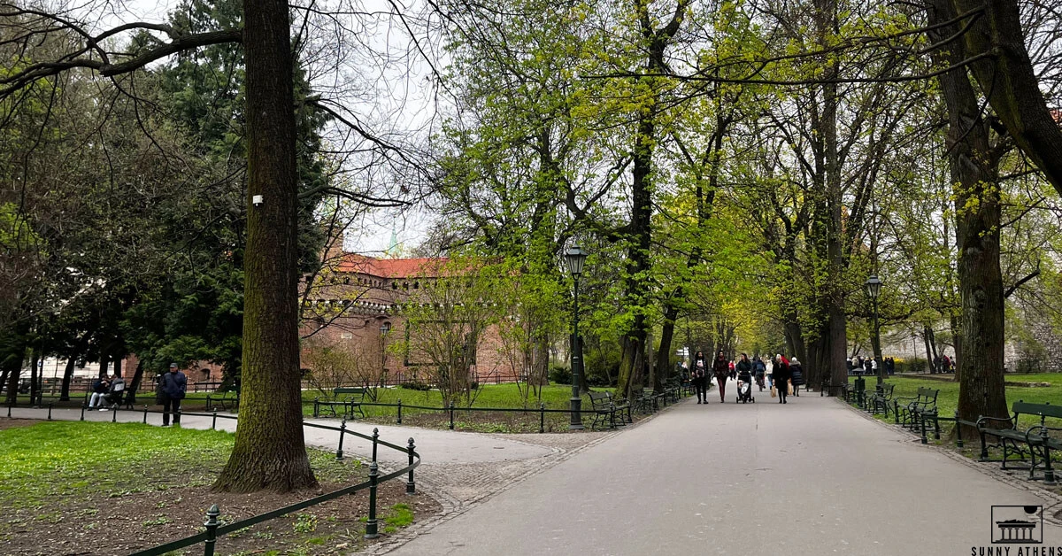 People walking on Planty, next to the Barbican of Krakow