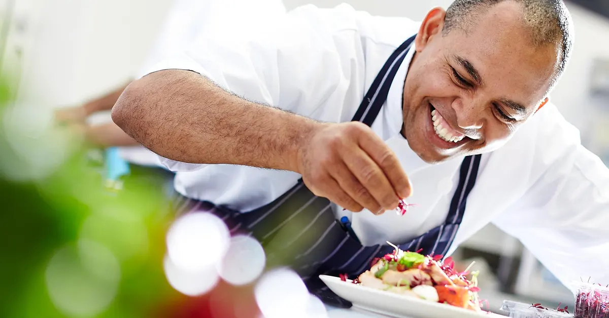 Athens Cooking Class: man smiling while cooking