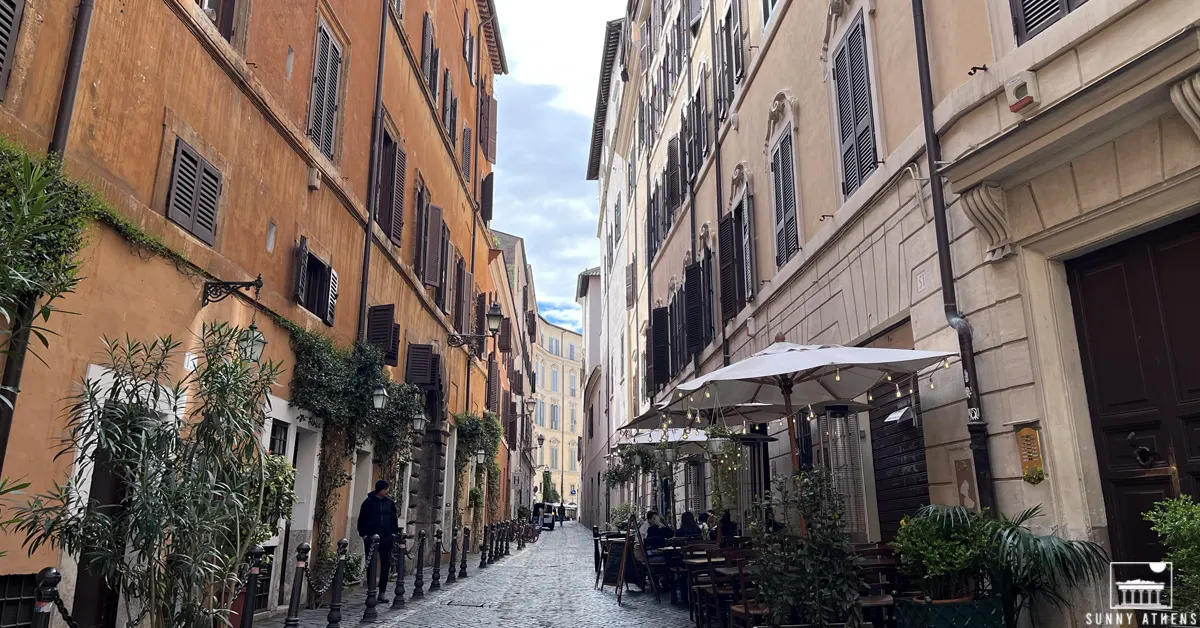 Picturesque cobbled alley with restaurants in Rome.