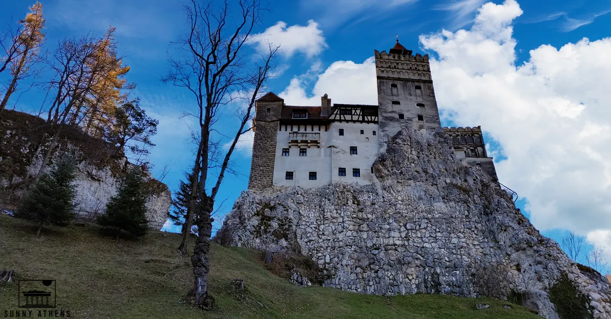 Unique Experiences in Brasov: the Bran Castle under a blue sky and some clouds.