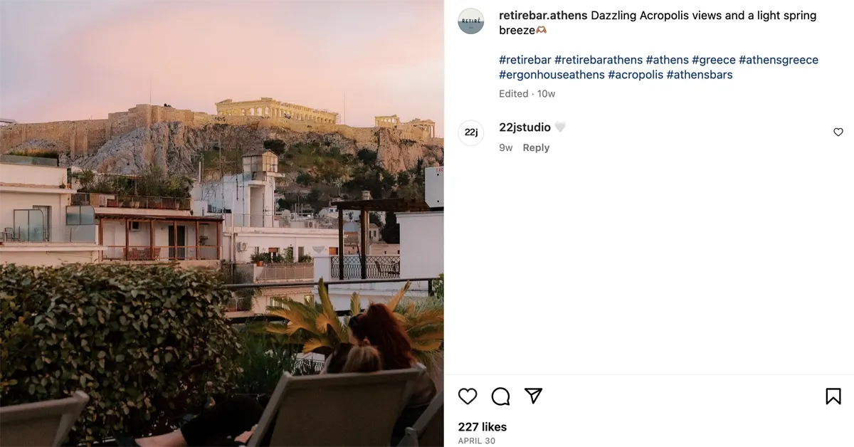 Best Rooftop bars in Athens: People chatting at ERGON House at sunset with the Acropolis in the background.