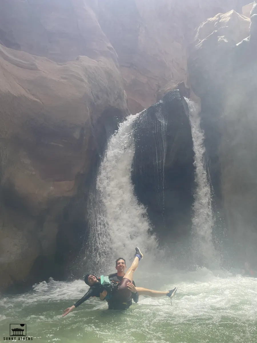 7 Days in Jordan Itinerary: Chrysavgi and I standing next to a small waterfall in Wadi Mujib.