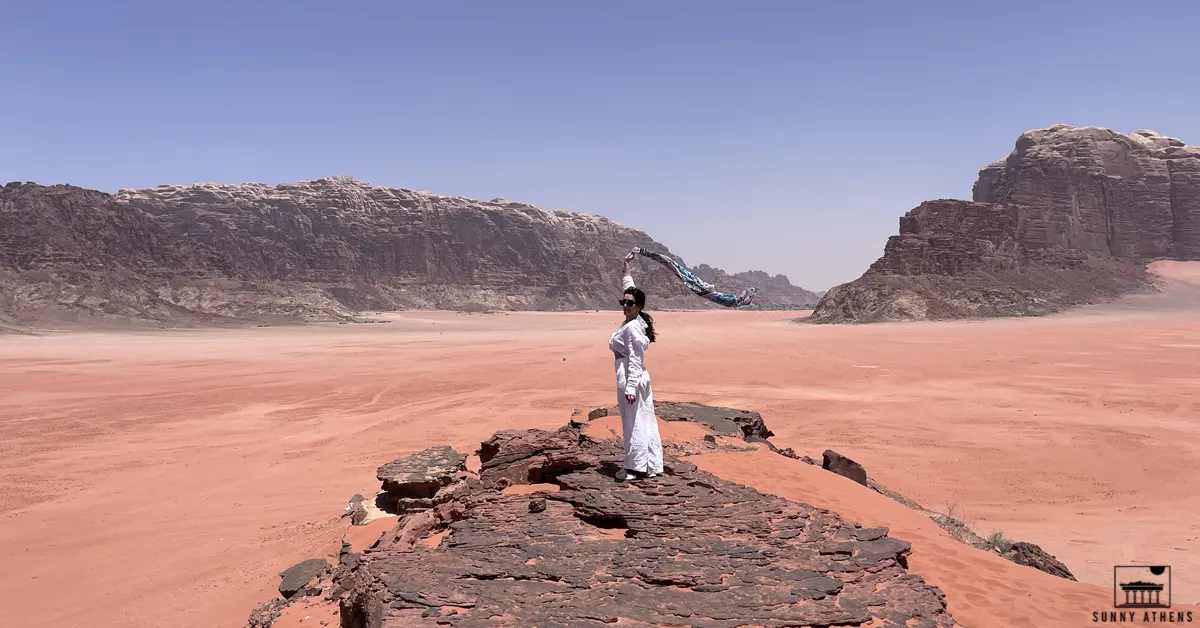 7 Days in Jordan Itinerary: Chrysavgi stands on a hill, taking in the breathtaking views of the Wadi Rum desert.