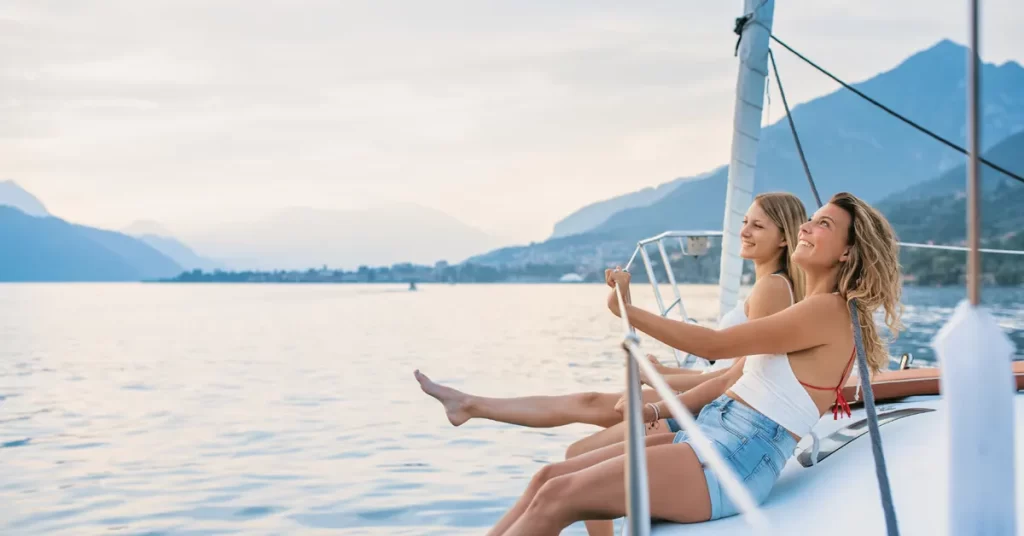 Best day trips from Athens: two girls sitting on the deck of a sailboat.