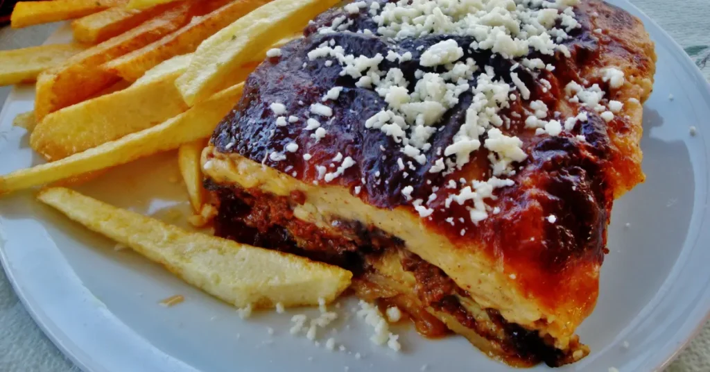 Local Food in Athens: a generous slice of moussaka, including potatoes, eggplants, minced meat, bechamel and grated cheese.