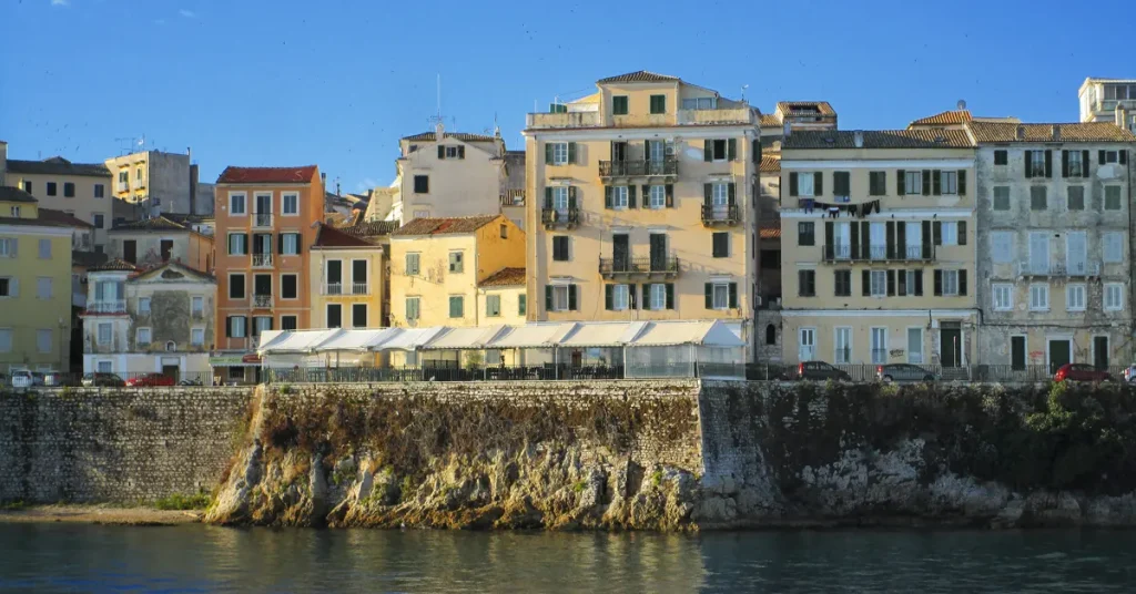 Colorful buildings along a seafront promenade in Corfu