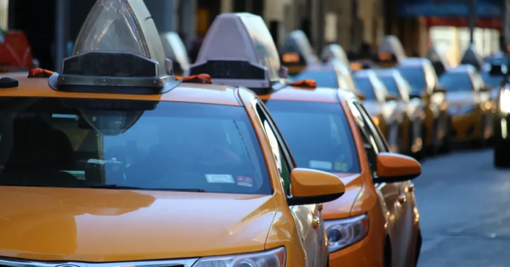 Uber in Corfu: A row of parked taxis with their roof lights turned off.