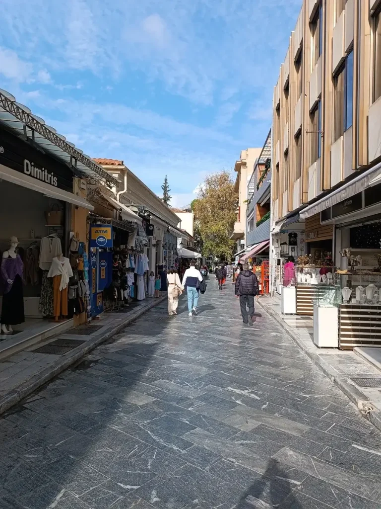 The view of Adriannou Street in Plaka, Athens, with people walking around and doing window-shopping.