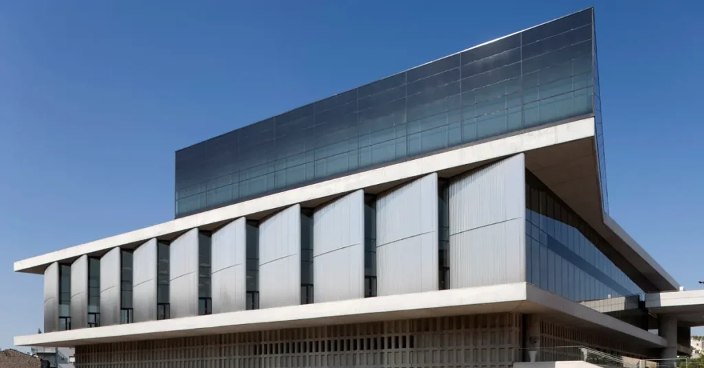 Side view of the Acropolis Museum with a clear blue sky in the background.