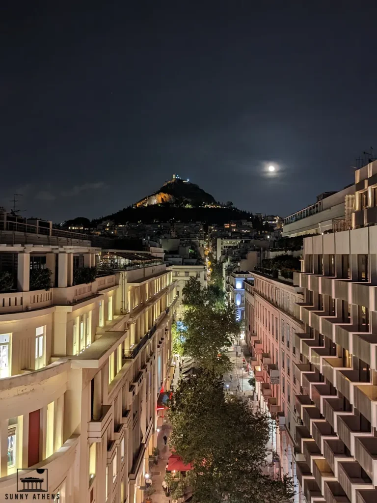 Night view of Lycabettus Hill under the moonlight, as seen from Stadiou street, next to Syntagma.