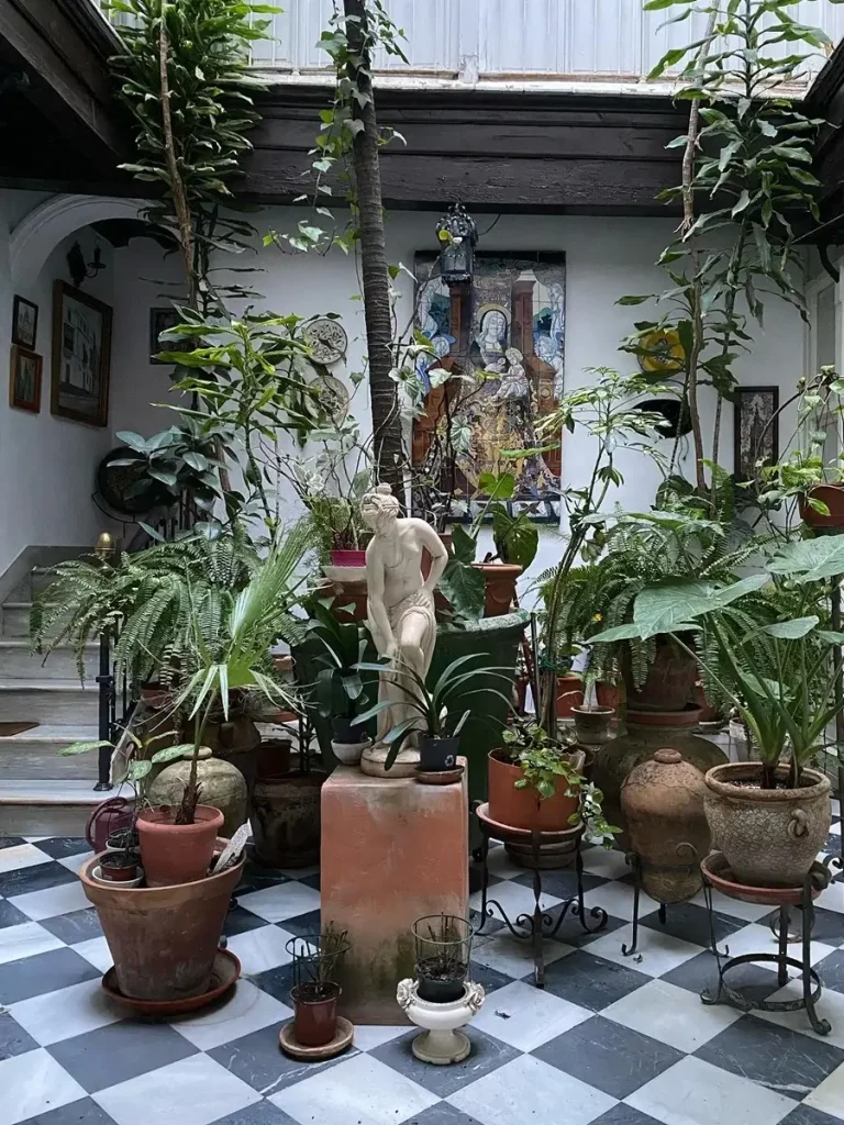 Plants and a small statue in the garden of Minu Athens in Psyrri area.