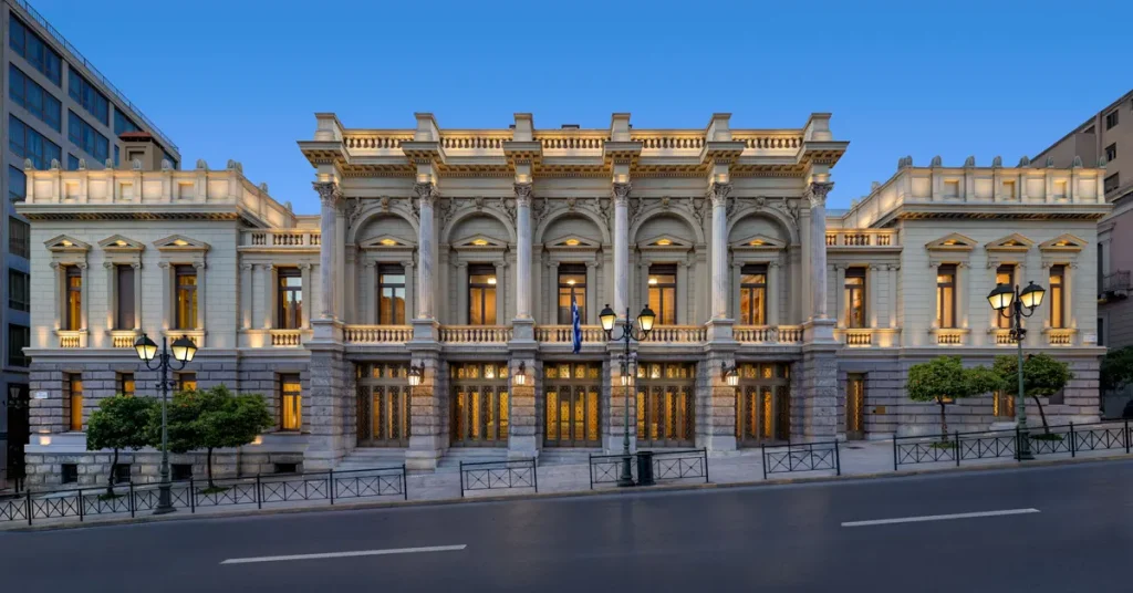 The neoclassical building of National Theatre of Greece illuminated at dusk.