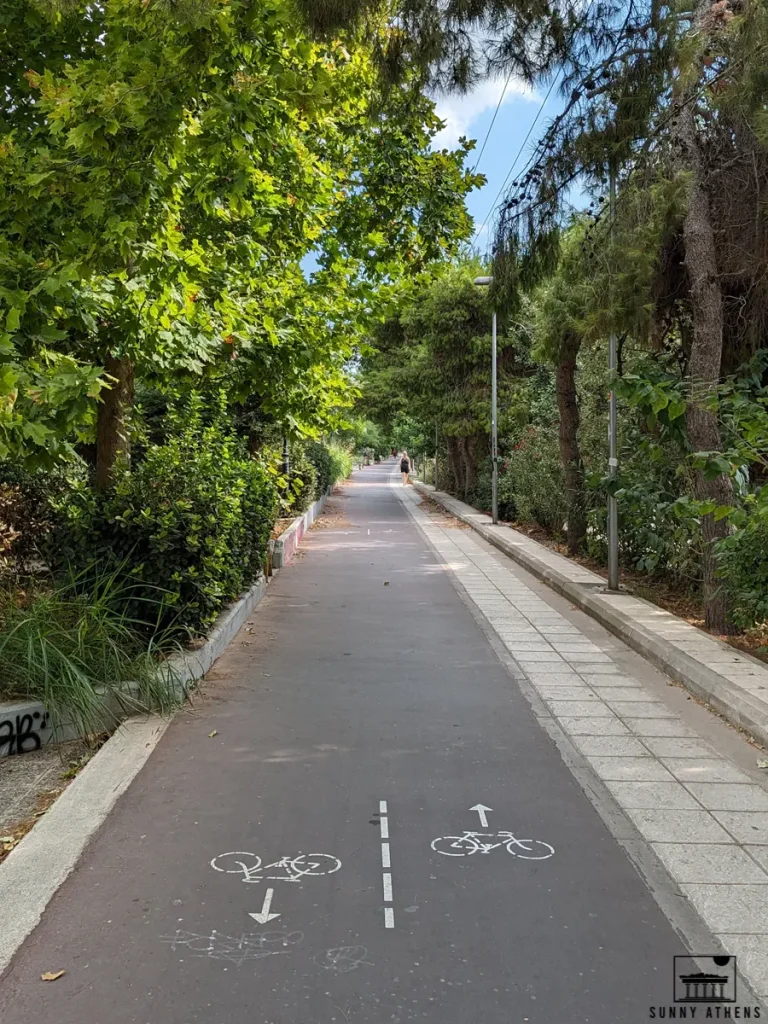 Bicycle lane in Athens surrounded by greenery.