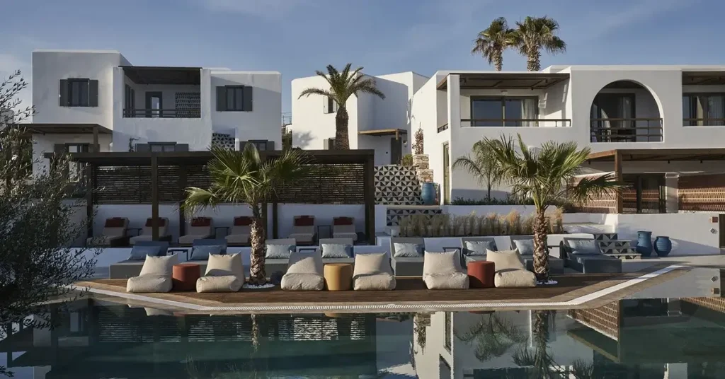 The pool of Andronis Minois hotel, with sunbebs around it, in Paros Greece.