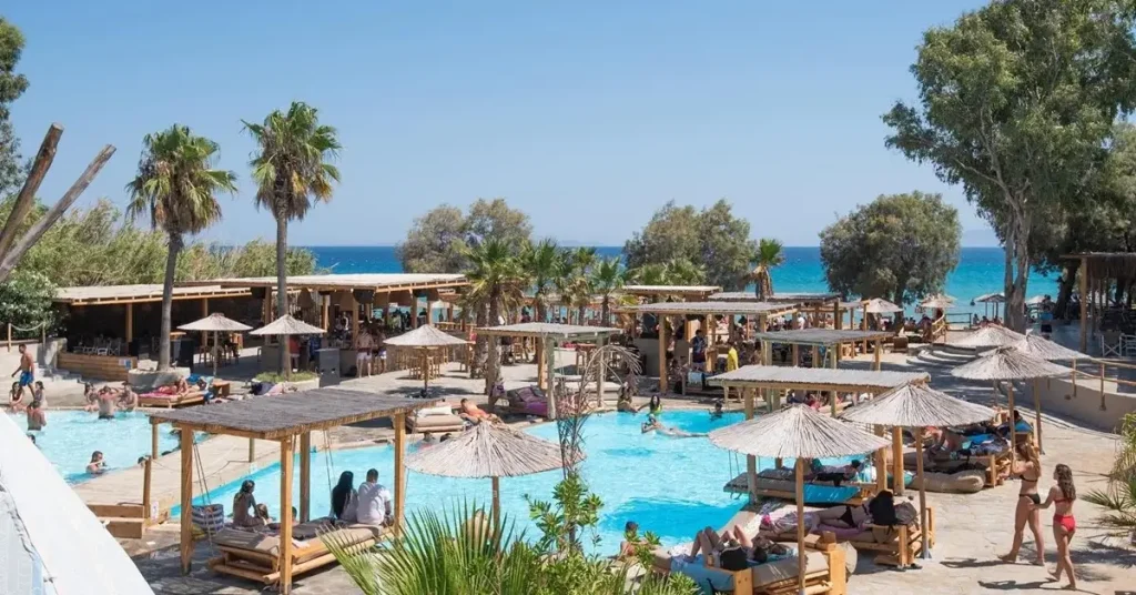 An outdoor swimming pool full of people at Paros Punda Beach Club.