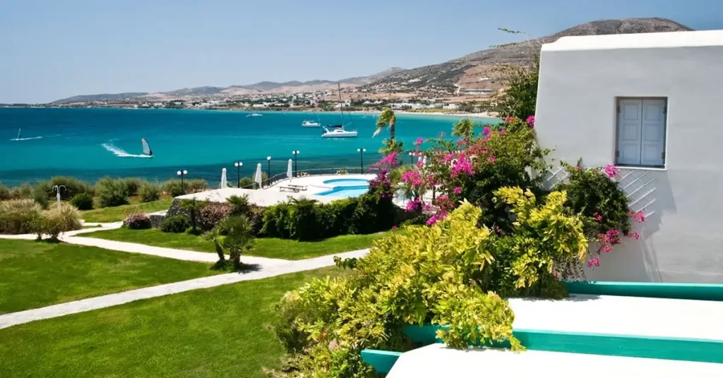 The garden of the Poseidon luxury hotel, overlooking the turquoise sea of Paros.