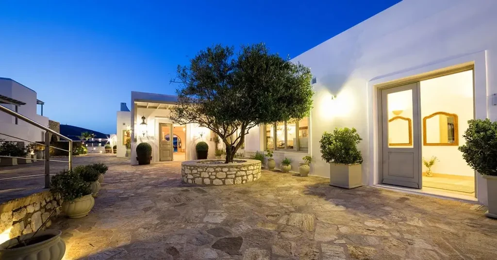 The entrance of Saint Andrea Resort in Paros, Greece, featuring an olive tree.