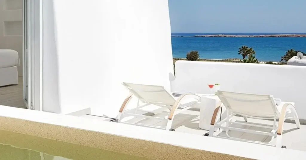 Two sunbeds looking at the sea as seen from the White Dunes Luxury Suites in Paros Greece.