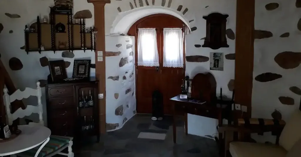 The living room and the small kitchen of the windmill hotel in Paros Greece.