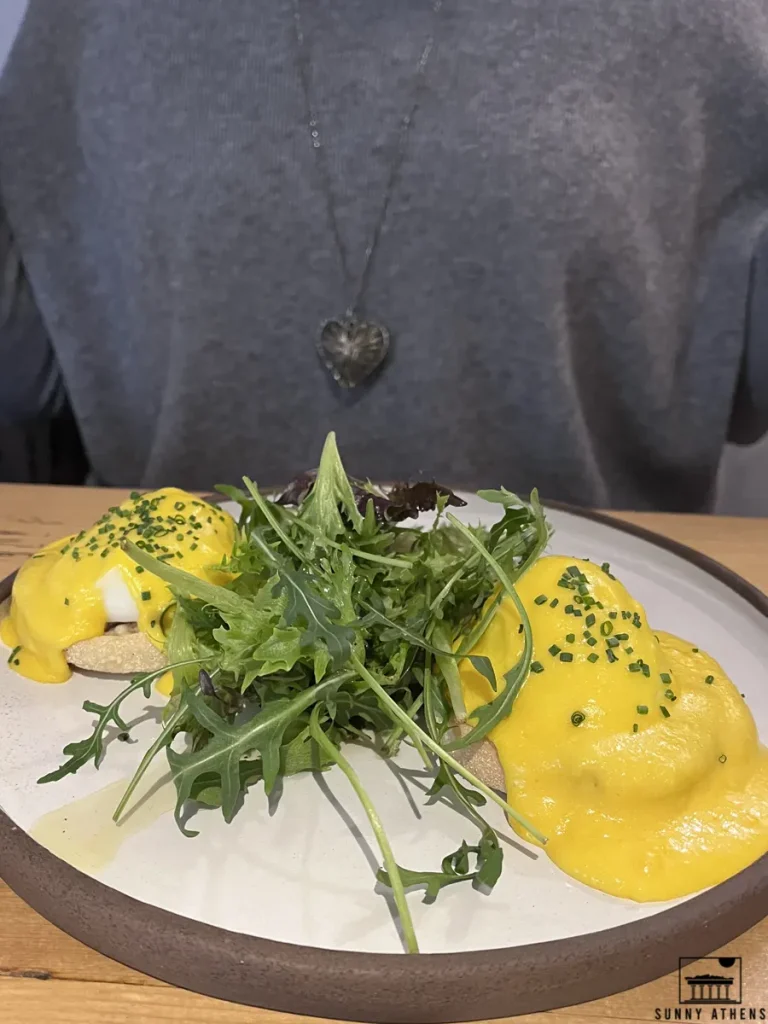 Eggs Benedict, generously topped with hollandaise sauce, served for brunch at Neratzia Café Bistrot.