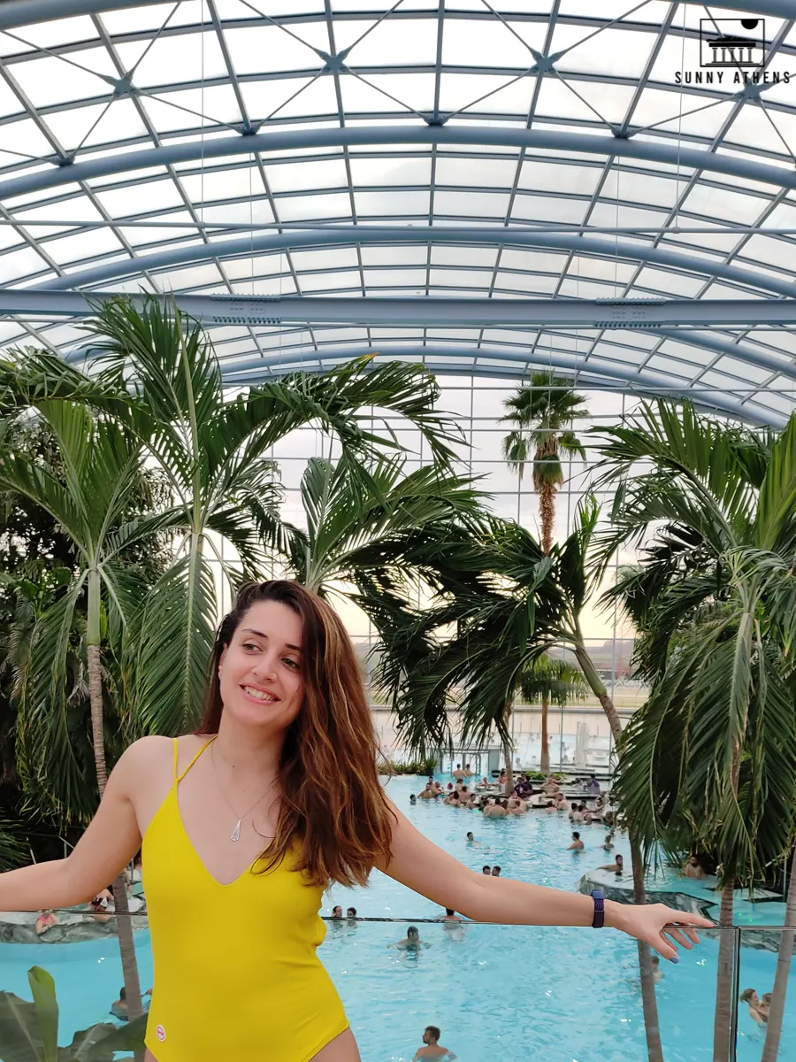 Chrysavgi smiling in front of the main pool of Therme Bucharest.