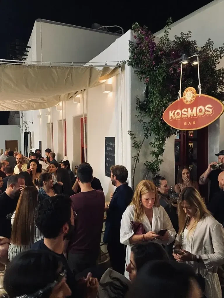 People chatting outside the beautiful Kosmos Bar in Naousa, Paros, Greece.