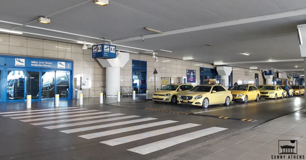 Yellow taxis waiting for passengers right outside the Gate 3 of Athens International Airport.