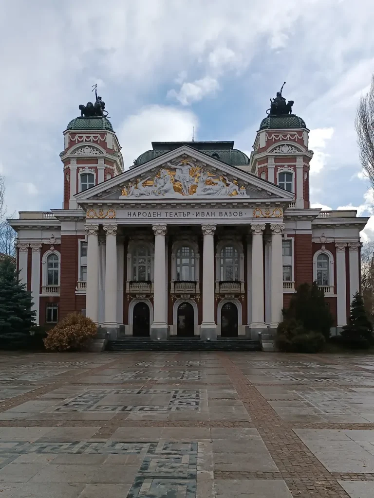 The stunning facade of the National Theater in Sofia, adorned with Ionic columns and a frieze.