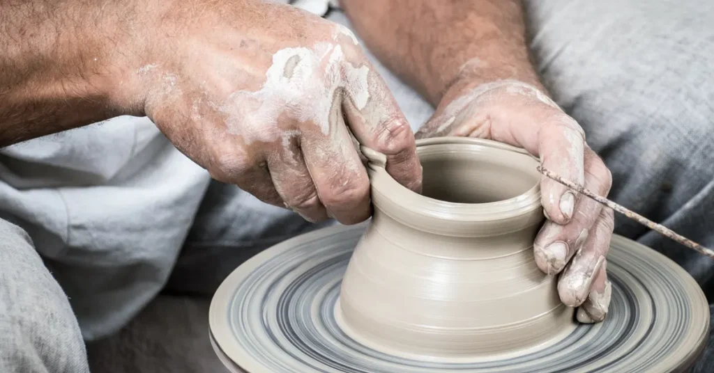 An artisan's hands creating pottery, emblematic of Athens' traditional crafts and ideal for an Off-The-Beaten-Path Itinerary For Families.