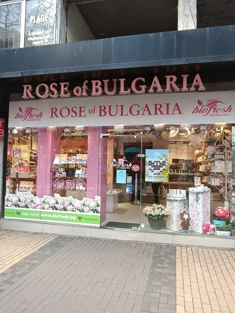 The 'Rose of Bulgaria' store front on Vitosha Blvd, decorated with flowers and pink-lettered stickers.