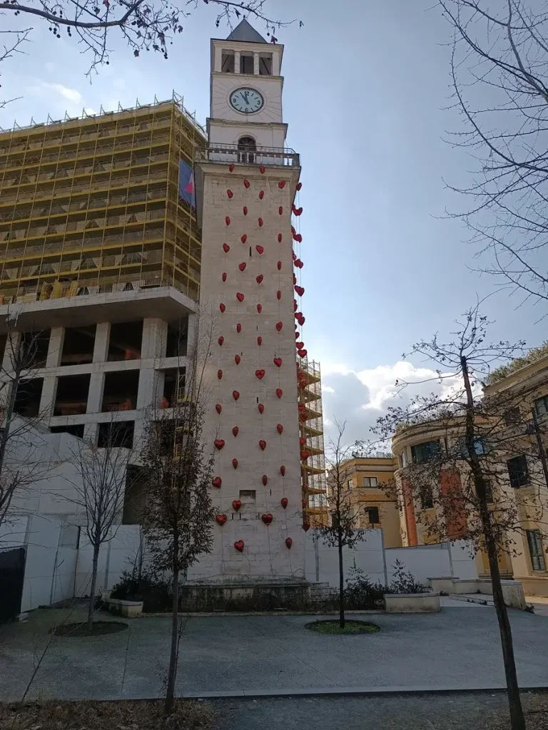 The clock tower, decorated with red heart balloons, in the center of Tirana, Albania.