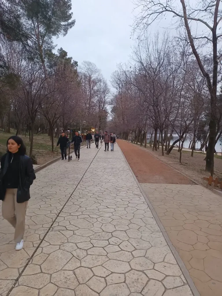 People walking and relaxing in the Grand Park of Tirana.