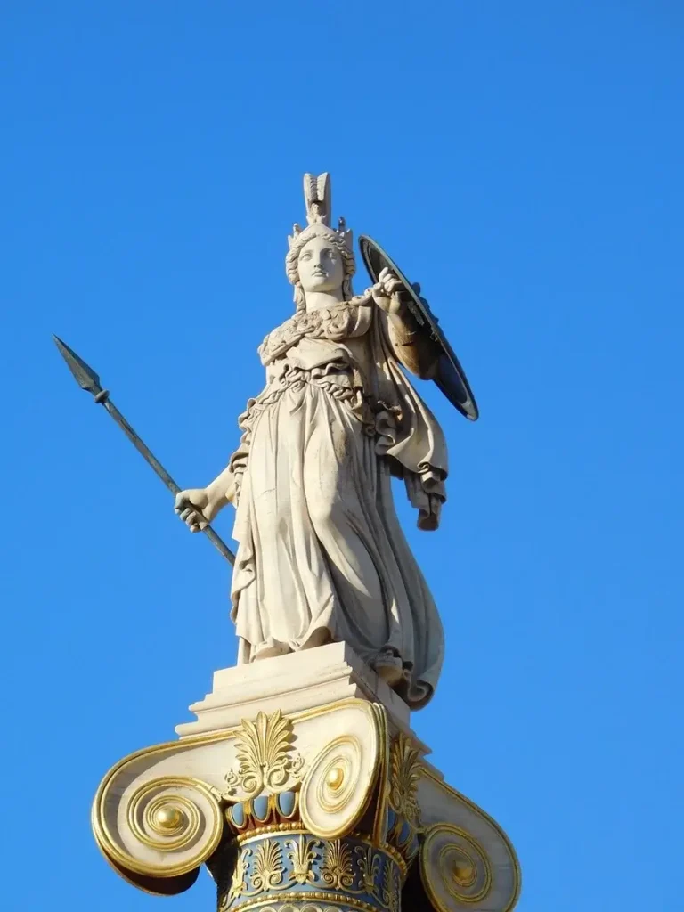 Acropolis myths and legends: Statue of the goddess Athena, holding a spear in her right hand and a shield in her left, placed atop an Ionic column.