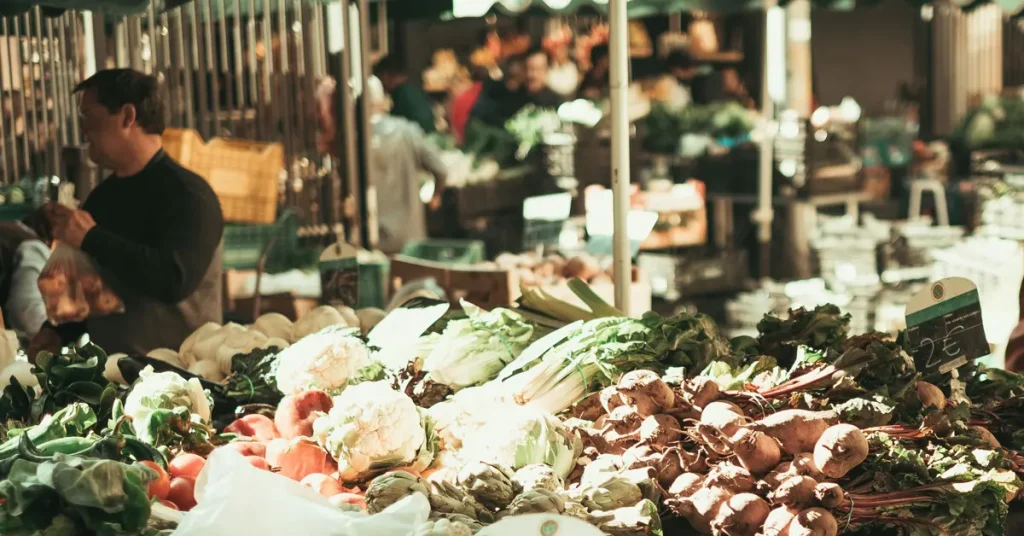 A shopper at a lively food market, highlighting the local produce explored on food tours in Athens for foodies.