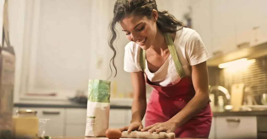 A woman preparing dough in a cooking class in Athens, ideal for hands-on experiences on food tours for foodies.